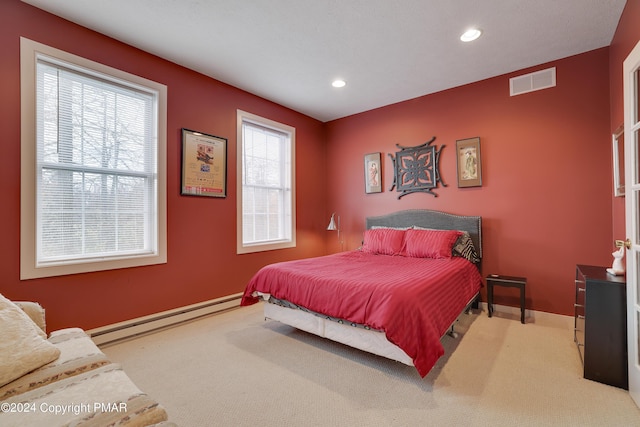 carpeted bedroom featuring a baseboard radiator, visible vents, baseboards, and recessed lighting