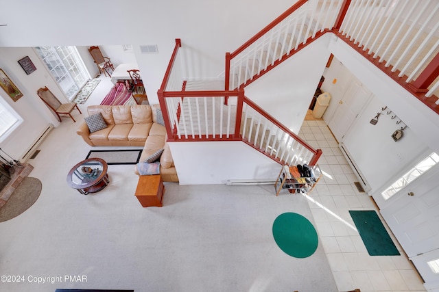 living room featuring visible vents, a towering ceiling, and stairs