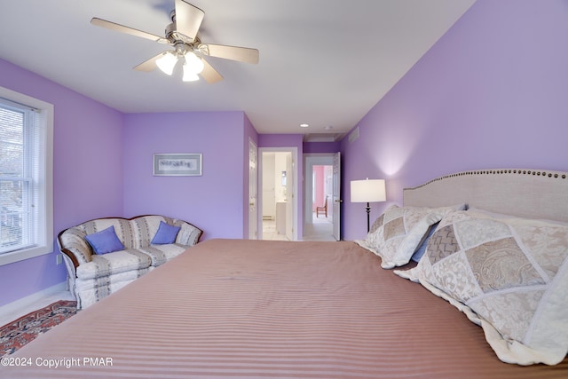 bedroom featuring connected bathroom and a ceiling fan