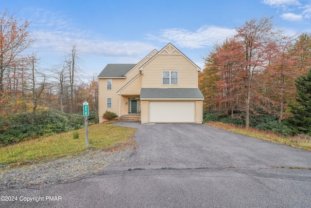 view of front of property with aphalt driveway and a garage