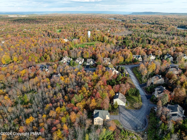 bird's eye view featuring a wooded view