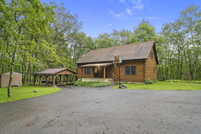 324 Hatchery Rd, Jim Thorpe, PA 18229 - log cabin with log siding, a front lawn, a porch, and driveway