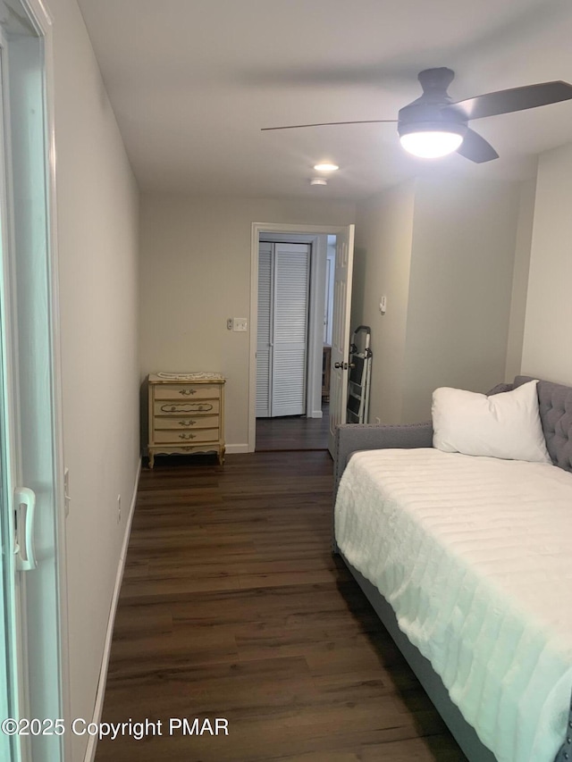 bedroom featuring dark wood-style floors, ceiling fan, and baseboards