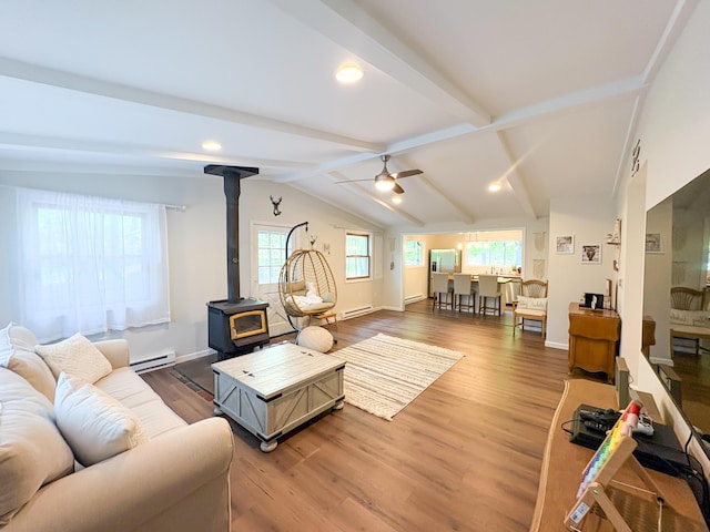 1085 Maple Lake Dr, Bushkill, PA 18324 - living area with a wood stove, a baseboard heating unit, a baseboard radiator, light wood finished floors, and a ceiling fan