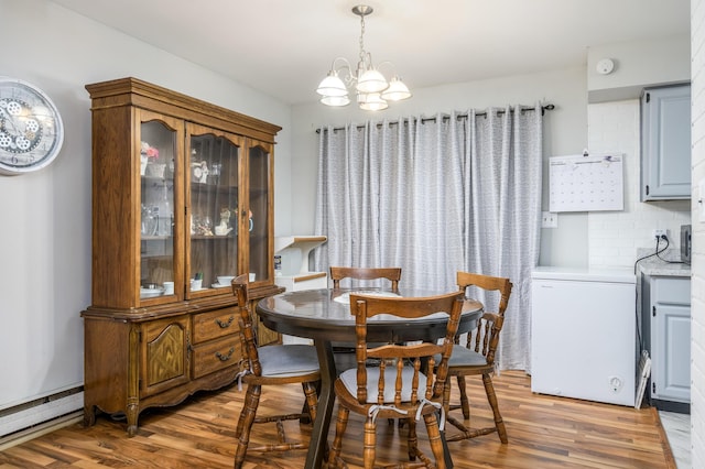 1259 Winding Way, Tobyhanna, PA 18466 - dining space featuring light wood-style floors, a chandelier, and a baseboard radiator