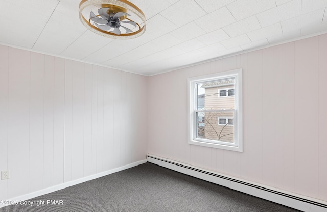 unfurnished room featuring baseboards, carpet, a baseboard heating unit, and a ceiling fan