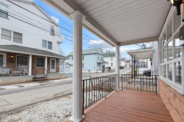 deck with a porch and a residential view