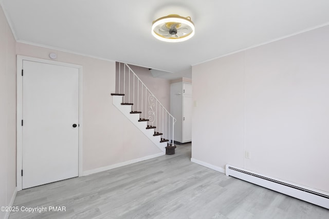 interior space featuring baseboards, a baseboard radiator, stairs, crown molding, and light wood-style floors