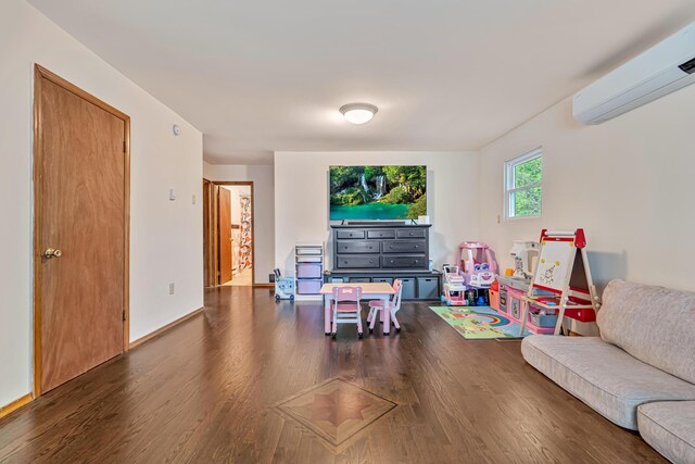 217 Coach Rd, Tobyhanna, PA 18466 - living room with a wall unit AC, wood finished floors, and baseboards