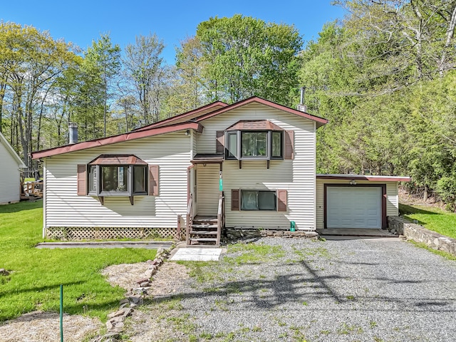 217 Coach Rd, Tobyhanna, PA 18466 - view of front of house featuring a garage, gravel driveway, and a front lawn