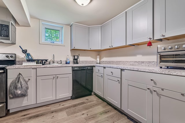 217 Coach Rd, Tobyhanna, PA 18466 - kitchen with appliances with stainless steel finishes, a sink, light wood finished floors, and light countertops