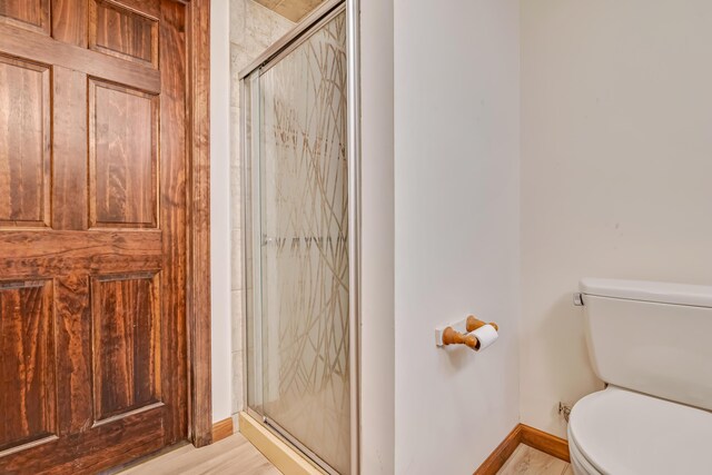 217 Coach Rd, Tobyhanna, PA 18466 - full bathroom with toilet, a shower stall, baseboards, and wood finished floors
