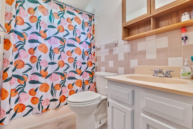 217 Coach Rd, Tobyhanna, PA 18466 - bathroom with vanity, toilet, tile walls, curtained shower, and tasteful backsplash