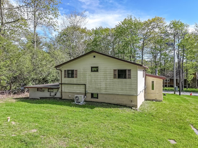 217 Coach Rd, Tobyhanna, PA 18466 - rear view of property with ac unit, a lawn, and view of wooded area