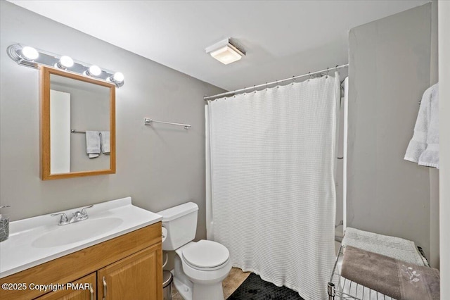 bathroom with vanity, toilet, and a shower with curtain