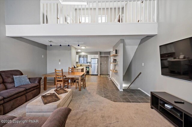 carpeted living room with a towering ceiling