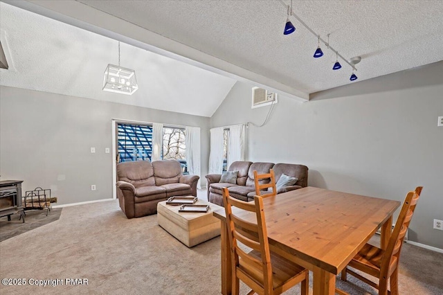 dining space featuring a wall unit AC, lofted ceiling with beams, a wood stove, a textured ceiling, and carpet flooring