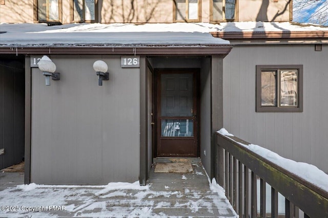 view of snow covered property entrance