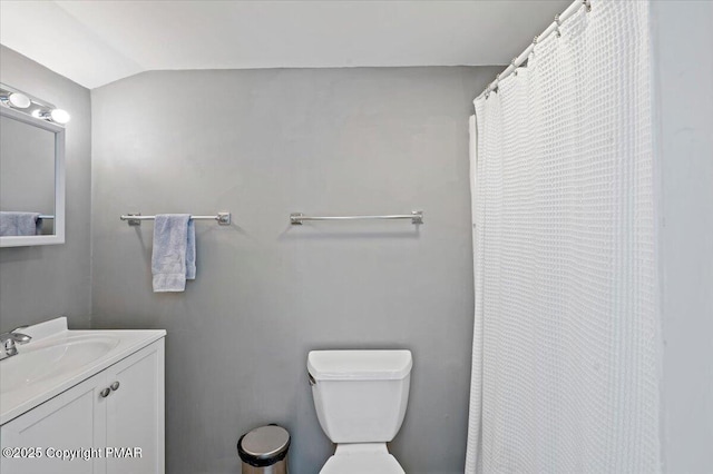 full bath with vaulted ceiling, vanity, and toilet