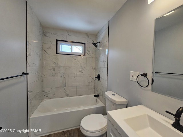 bathroom featuring washtub / shower combination, vanity, toilet, and wood finished floors