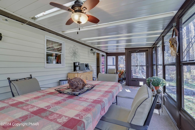 sunroom featuring ceiling fan