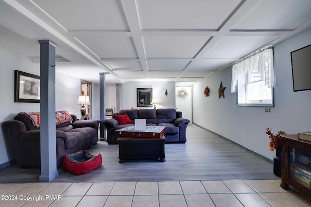 living room with light wood-type flooring, ornate columns, coffered ceiling, and baseboards