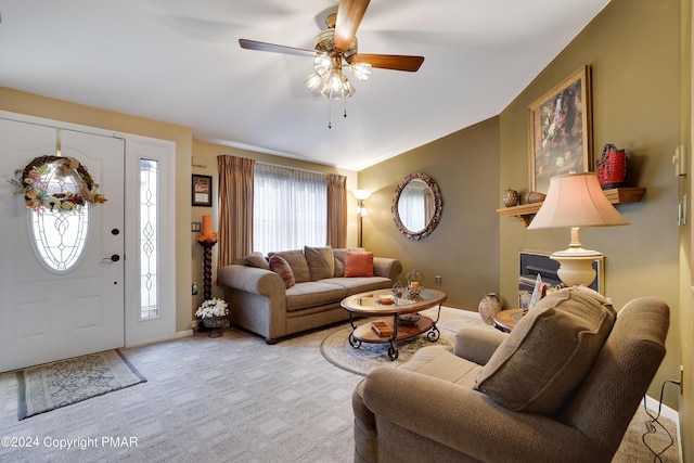 living area with carpet floors, ceiling fan, baseboards, and vaulted ceiling