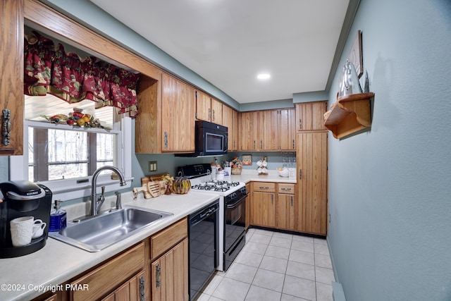 kitchen featuring light countertops, brown cabinetry, light tile patterned flooring, a sink, and black appliances