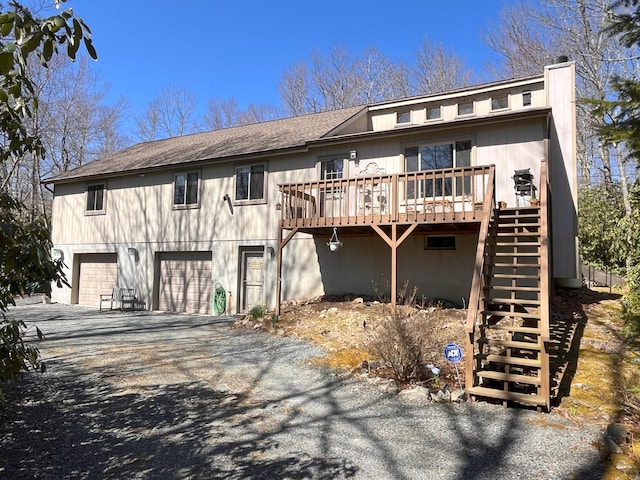 5 Cayuga Dr, Jim Thorpe, PA 18229 - view of front of property featuring an attached garage, a chimney, aphalt driveway, stairs, and a wooden deck