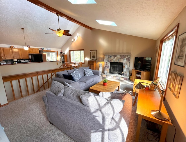 5 Cayuga Dr, Jim Thorpe, PA 18229 - living area featuring vaulted ceiling with skylight, a textured ceiling, carpet, and a wealth of natural light