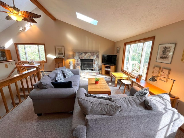 5 Cayuga Dr, Jim Thorpe, PA 18229 - living room featuring a stone fireplace, a textured ceiling, a ceiling fan, carpet, and vaulted ceiling with beams