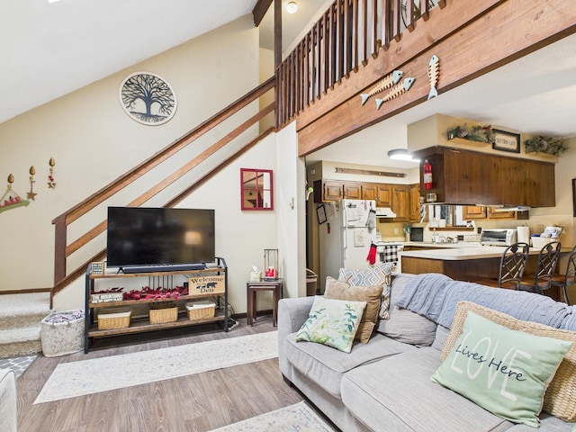 179 Choctaw Dr, Pocono Lake, PA 18347 - living room featuring high vaulted ceiling, light wood finished floors, baseboards, and stairway