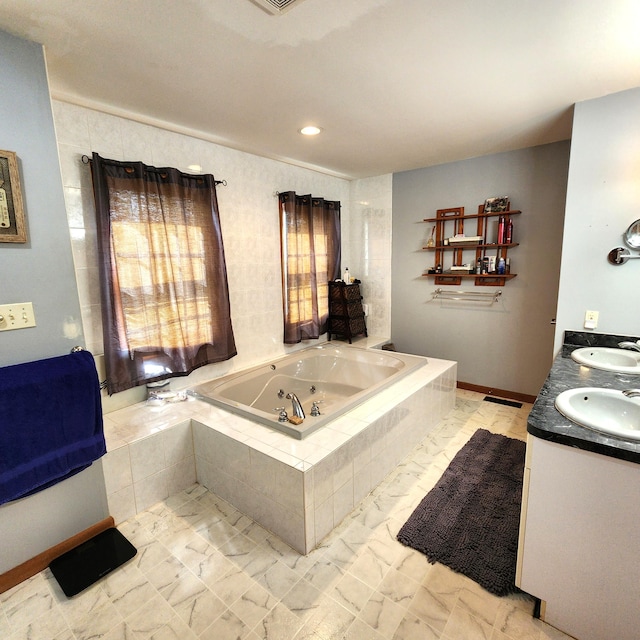 408 Sassafrass Way, Stroudsburg, PA 18360 - bathroom featuring a tub with jets, double vanity, marble look tile flooring, and recessed lighting