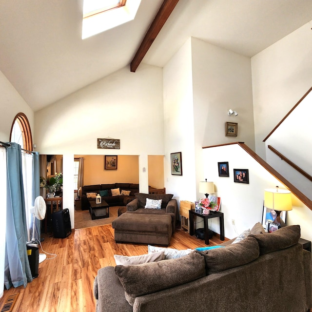 408 Sassafrass Way, Stroudsburg, PA 18360 - living area featuring high vaulted ceiling, wood finished floors, stairs, and beam ceiling