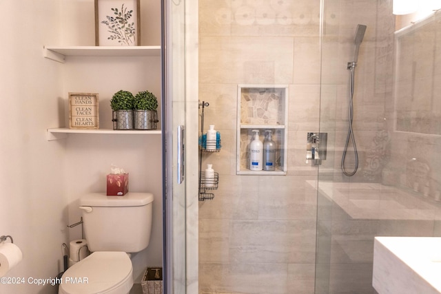 full bathroom with toilet and a tile shower