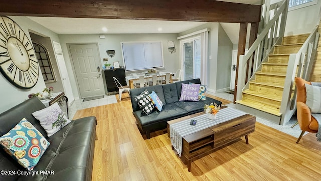 living area featuring recessed lighting, baseboards, light wood finished floors, and stairs