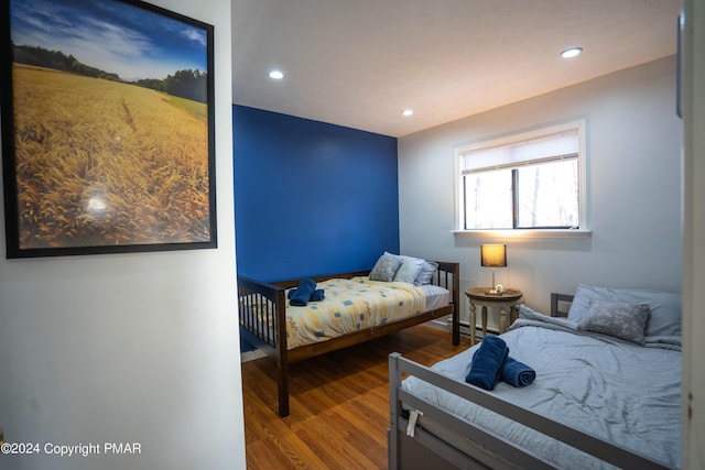 bedroom with recessed lighting, baseboards, a baseboard heating unit, and wood finished floors