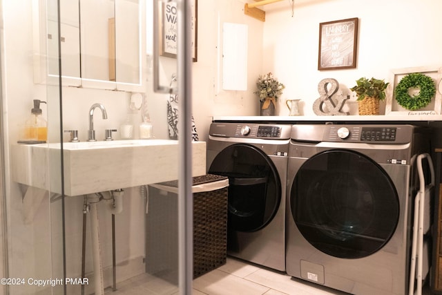 washroom with laundry area, tile patterned floors, and separate washer and dryer