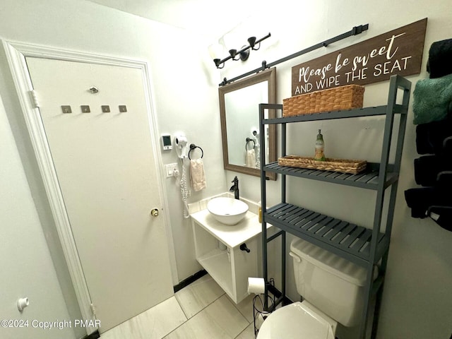 bathroom with vanity, tile patterned floors, and toilet