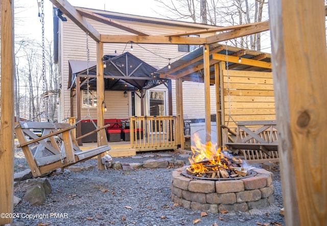 view of patio / terrace featuring a gazebo, a fire pit, and a wooden deck