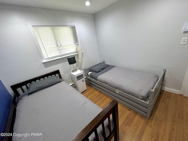 bedroom with baseboards and wood finished floors