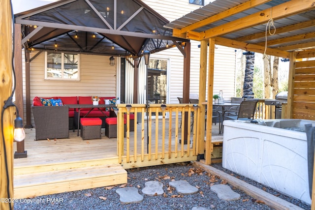 wooden deck featuring an outdoor hangout area, outdoor dining space, a gazebo, and grilling area