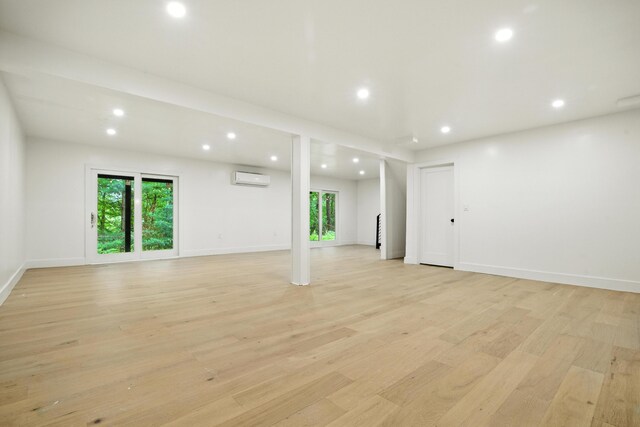 16 Norman Dr, East Stroudsburg, PA 18302 - unfurnished living room featuring recessed lighting, a wall mounted air conditioner, and light wood-type flooring