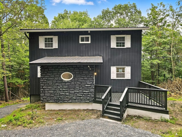 16 Norman Dr, East Stroudsburg, PA 18302 - view of front facade featuring stone siding, a metal roof, and a wooden deck