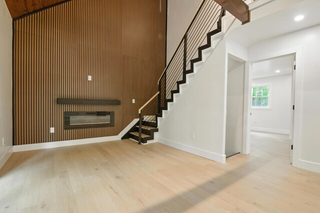 16 Norman Dr, East Stroudsburg, PA 18302 - stairway featuring wood finished floors, a glass covered fireplace, and recessed lighting