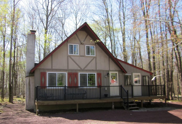 view of front facade with a chimney and a deck
