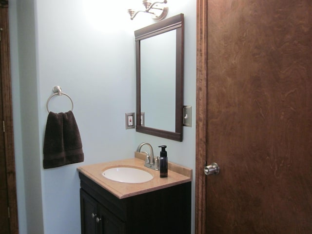 bathroom with an inviting chandelier and vanity