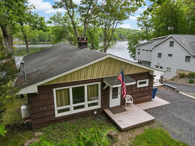 300 Indian Lake Trl, White Haven, PA 18661 - back of property with a chimney, board and batten siding, a deck with water view, and a shingled roof