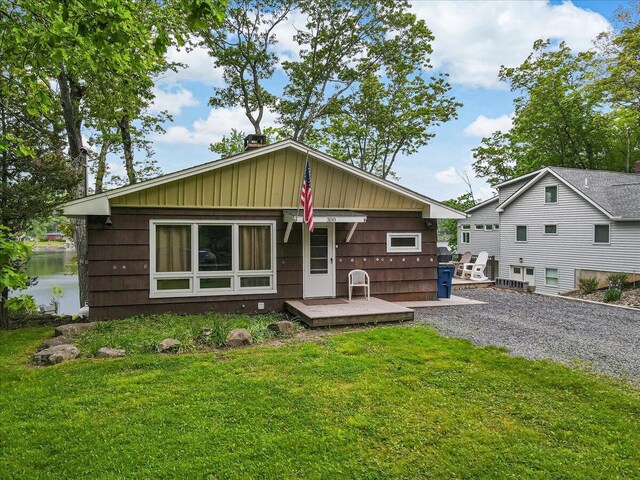 300 Indian Lake Trl, White Haven, PA 18661 - rear view of house featuring a lawn, board and batten siding, and a deck with water view