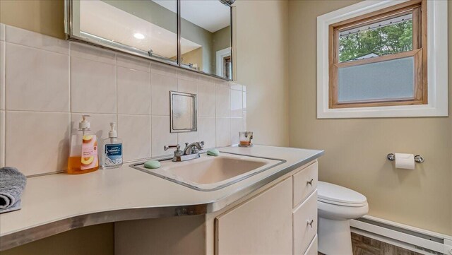 300 Indian Lake Trl, White Haven, PA 18661 - bathroom with a baseboard radiator, toilet, vanity, and tasteful backsplash